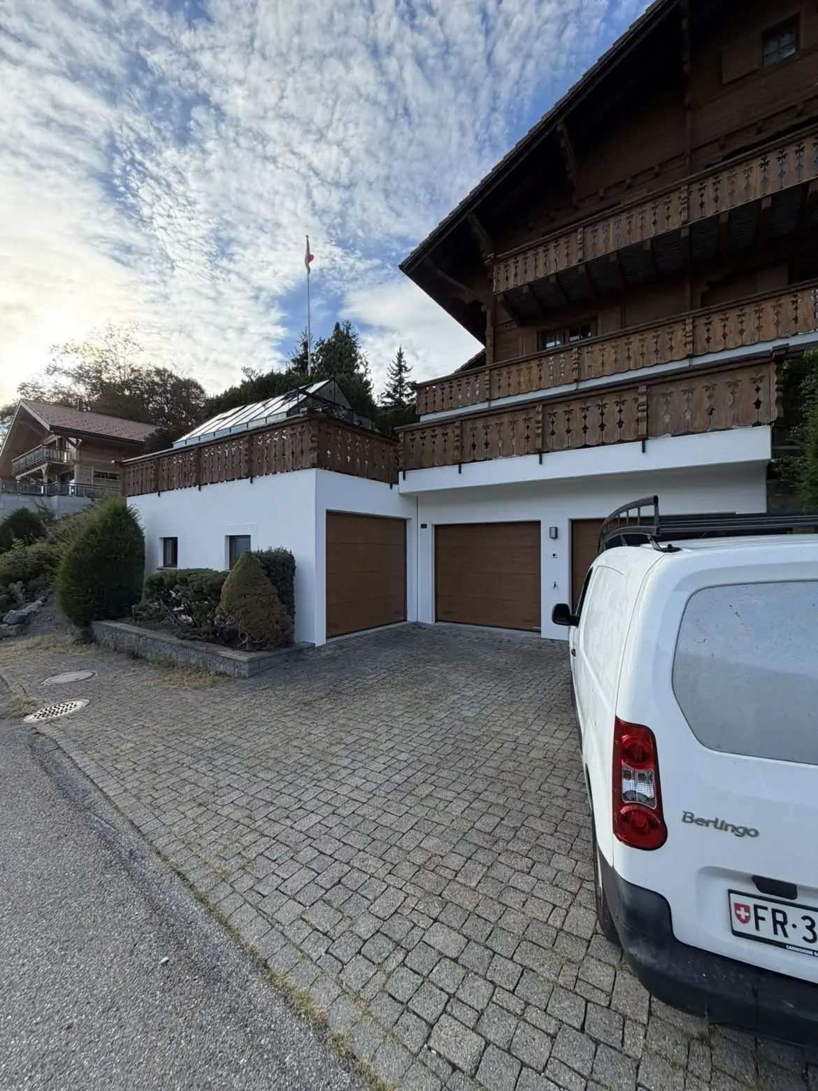Le chalet vu depuis la rue, boiseries de balcon repassées à la lasure